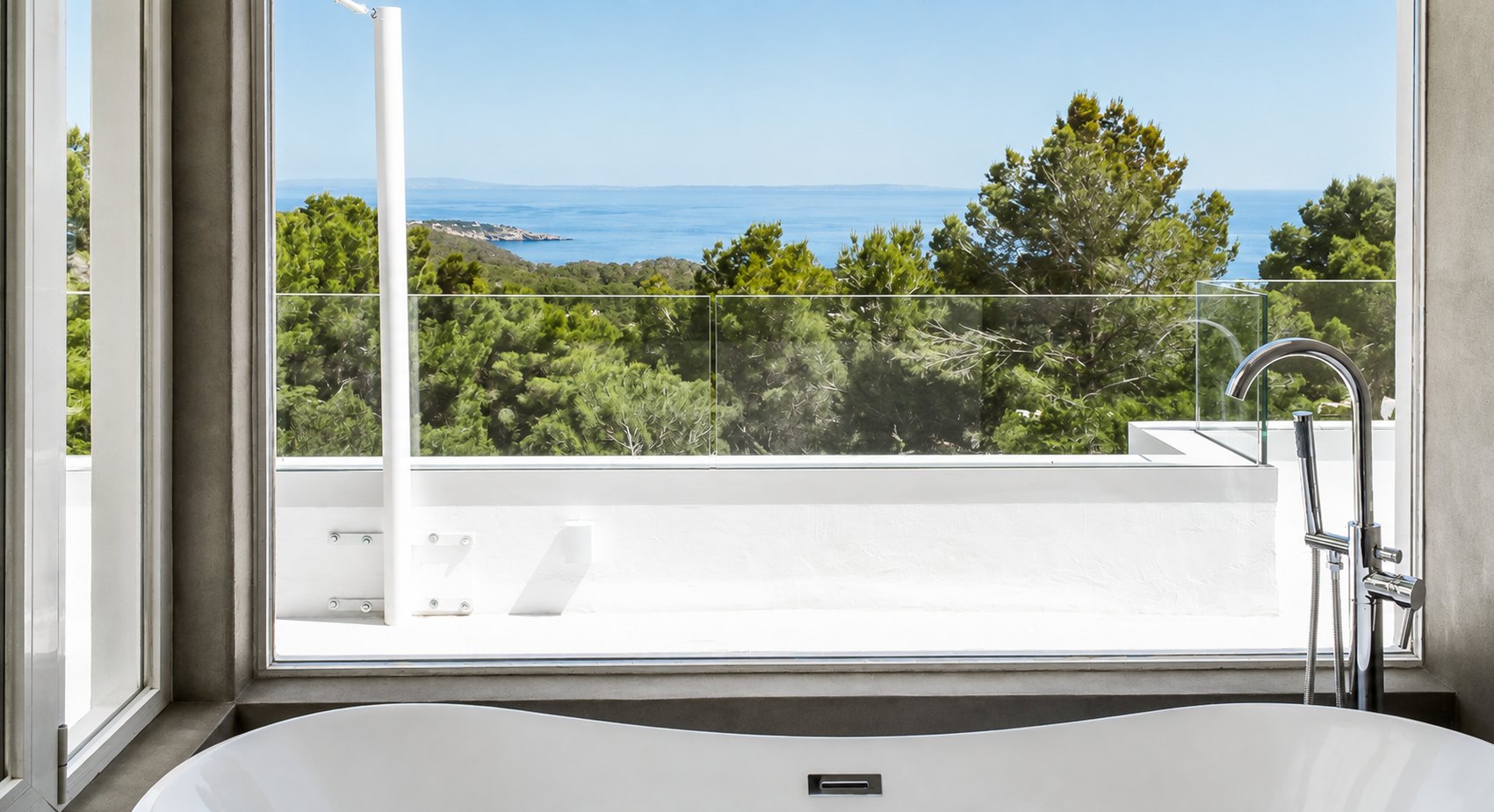 Villa bathroom with a freestanding bath overlooking the sea
